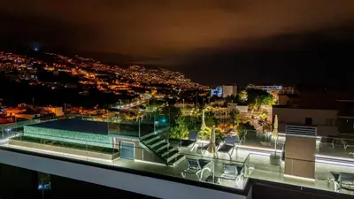 a pillow sitting on top of a bed with pillows at Casa da Ilha in Funchal