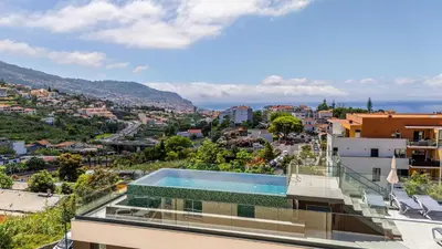 a view of a city at night at Casa da Ilha in Funchal