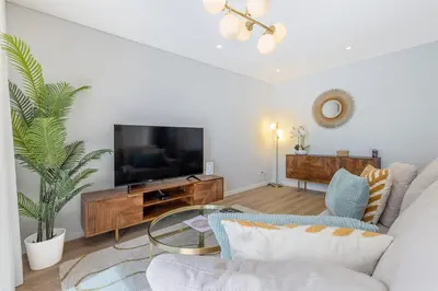 a living room with a couch and a tv at Casa da Ilha in Funchal