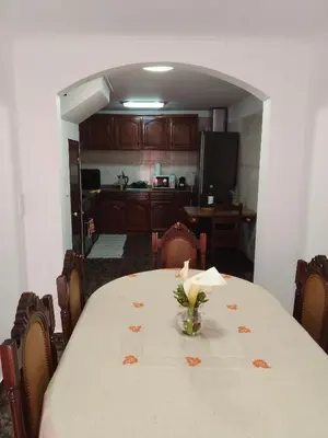 a bedroom with a bed with a floral comforter at Refugio Catanho in São Vicente