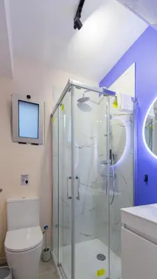 a bathroom with a shower and a toilet at The Jolie - Porto Moniz Central Studios in Porto Moniz