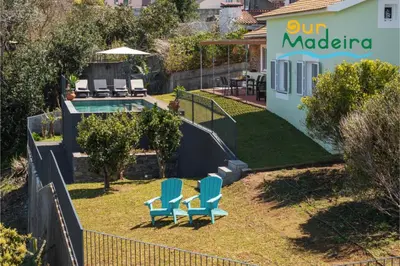 a yard with two chairs and a swimming pool at Tranquil Villa Close to Facilities - NatureScape in Prazeres