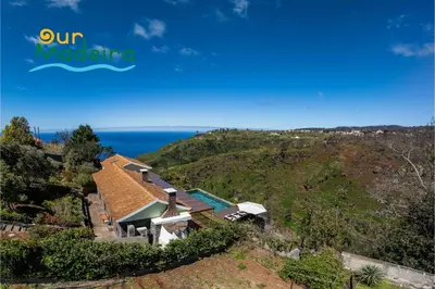 an aerial view of a house on a hill with the ocean at Tranquil Villa Close to Facilities - NatureScape in Prazeres