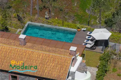 an overhead view of a swimming pool with an umbrella at Tranquil Villa Close to Facilities - NatureScape in Prazeres