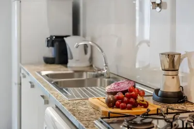 a kitchen counter with a cutting board with food on it at Madeira Emotions II, By OP in Funchal