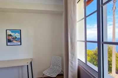 a room with a chair next to a window at Desertas Vista Ninho by LovelyStay in Gaula