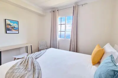 a bedroom with a white bed and a window at Desertas Vista Ninho by LovelyStay in Gaula