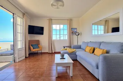 a living room with a couch and a table at Desertas Vista Ninho by LovelyStay in Gaula