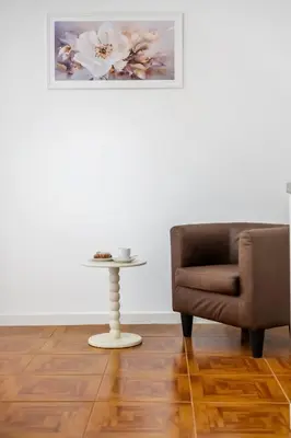 a living room with a chair and a table at Por Do Sol in Calheta