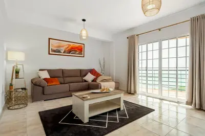 a living room with a couch and a table at Por Do Sol in Calheta