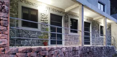 a brick house with a stone wall at Paradise House in Ponta do Sol