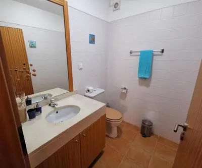 a bathroom with a sink and a toilet at Sea & Sand Guest House in Porto Santo