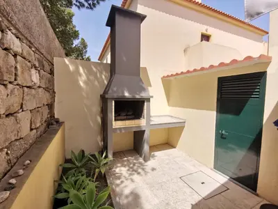 a fireplace in the courtyard of a house at Sea & Sand Guest House in Porto Santo