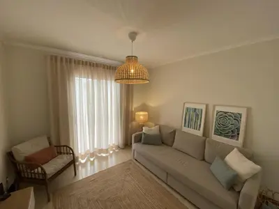 a living room with a couch and a chandelier at Villas Dragoeiro in Porto Santo