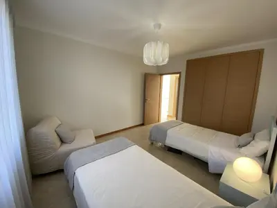 a hotel room with two beds and a couch at Villas Dragoeiro in Porto Santo