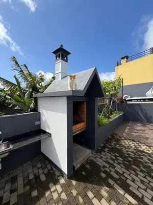 a dog house with a lighthouse on the roof at Casa do Farol Guest House in São Jorge