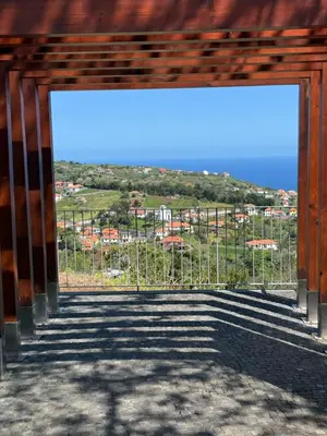 an open gate with a view of the ocean at Casa do Farol Guest House in São Jorge