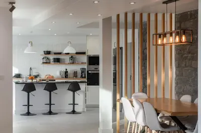 a kitchen and dining room with a table and chairs at With pool and sea view - Vila da Ribeira da Vaca in Calheta