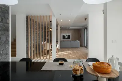 a dining room and living room with a table at With pool and sea view - Vila da Ribeira da Vaca in Calheta
