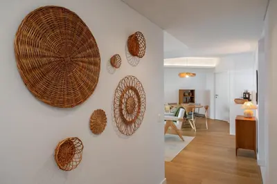 a living room with a wall with wicker plates at With pool and sea view - Acqua Residence III in Funchal