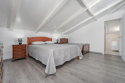 a bedroom with a bed and a dresser in it at Casa Vale da Laurissilva in São Vicente