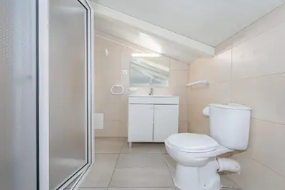 a bathroom with a toilet and a shower at Casa Vale da Laurissilva in São Vicente