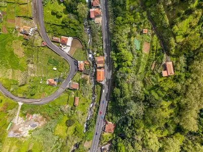 an overhead view of a road and houses and trees at River Side in Senhora do Rosário