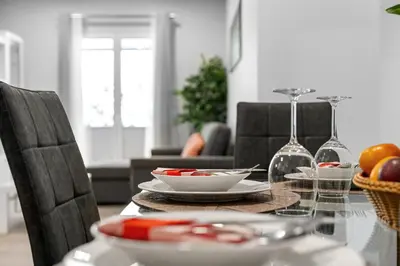 a dining room table with plates and wine glasses at River Side in Senhora do Rosário