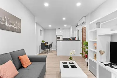 a living room with a couch and a tv at River Side in Senhora do Rosário