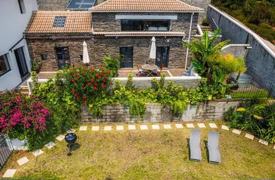 an aerial view of a house with a garden at NEW! Nature Paradise with Ocean View & Hot Tubs in Fajã da Ovelha