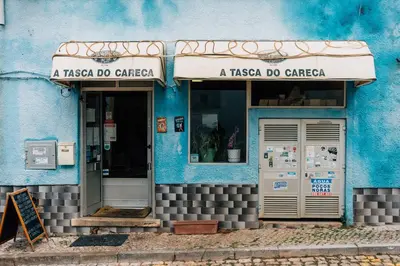 aitating blue building with a pizza do garage at Cozy Old Town Apartment with Sunny Terrace in Vila do Bispo