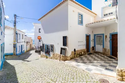 a street in a town with white buildings at Casa Maisie Apartment in Burgau