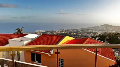 a bedroom with a bed and a mirror on a table at Casa Mollivia - Breath taking views over Funchal in Funchal
