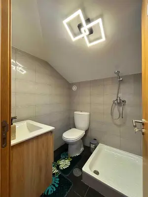 a bathroom with a toilet and a tub and a shower at A SELVA T2 in Caniço in Caniço