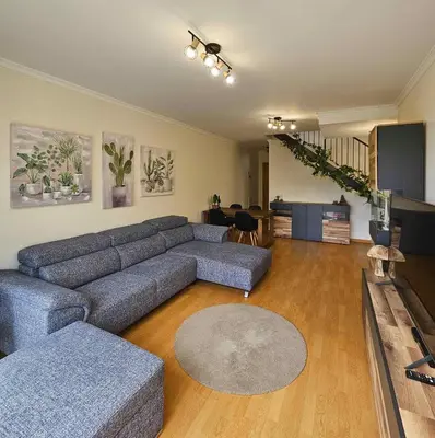 a living room with a couch and a table at A SELVA T2 in Caniço in Caniço