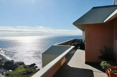 a view of the ocean from the balcony of a building at Aylevarroo Penthouse in Caniço