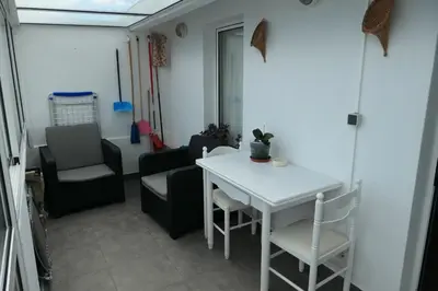 a small room with a white table and chairs at Aylevarroo Penthouse in Caniço