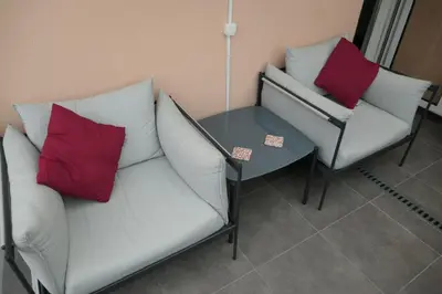 a living room with two chairs and a table at Aylevarroo Penthouse in Caniço