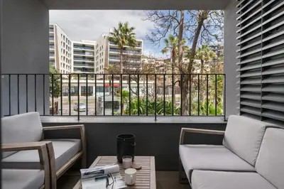 a balcony with two couches and a view of a city at With pool in Funchal - Acqua Residence V in Funchal