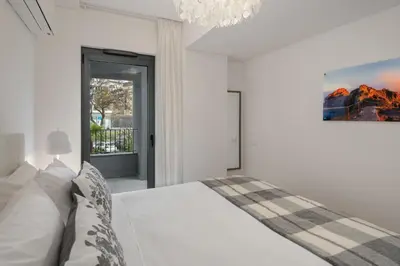 a white bedroom with a bed and a chandelier at With pool in Funchal - Acqua Residence V in Funchal