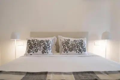 a large bed with two pillows and a white bedspread at With pool in Funchal - Acqua Residence V in Funchal