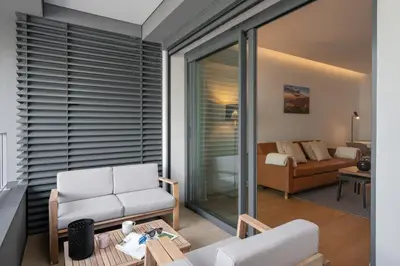 a living room with white chairs and a couch at With pool in Funchal - Acqua Residence V in Funchal