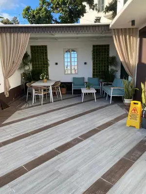 a patio with a table and chairs on it at Comboio Funchal in Funchal