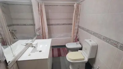 a bathroom with a toilet and a sink and a tub at Comboio Funchal in Funchal