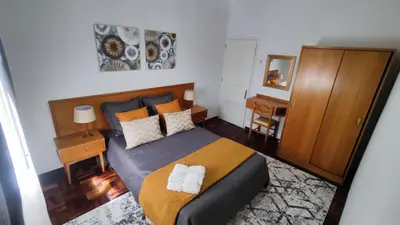 a bedroom with a bed with two towels on it at Comboio Funchal in Funchal