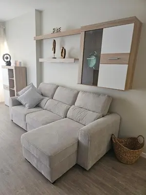 a living room with a couch and a mirror at Gratitude Apartment in Funchal