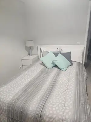a bedroom with a bed with two pillows on it at Gratitude Apartment in Funchal