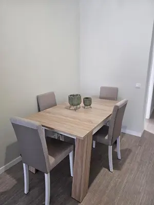 a wooden table with four chairs and a bowl on it at Gratitude Apartment in Funchal