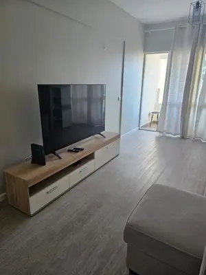 a living room with a flat screen tv on a entertainment center at Gratitude Apartment in Funchal