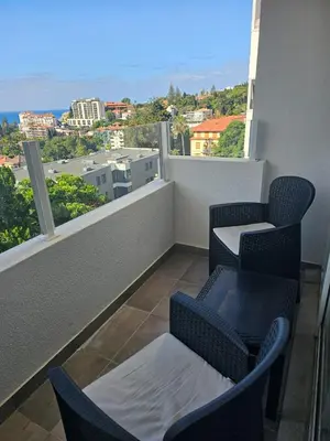 a balcony with two chairs and a table and a view at Gratitude Apartment in Funchal